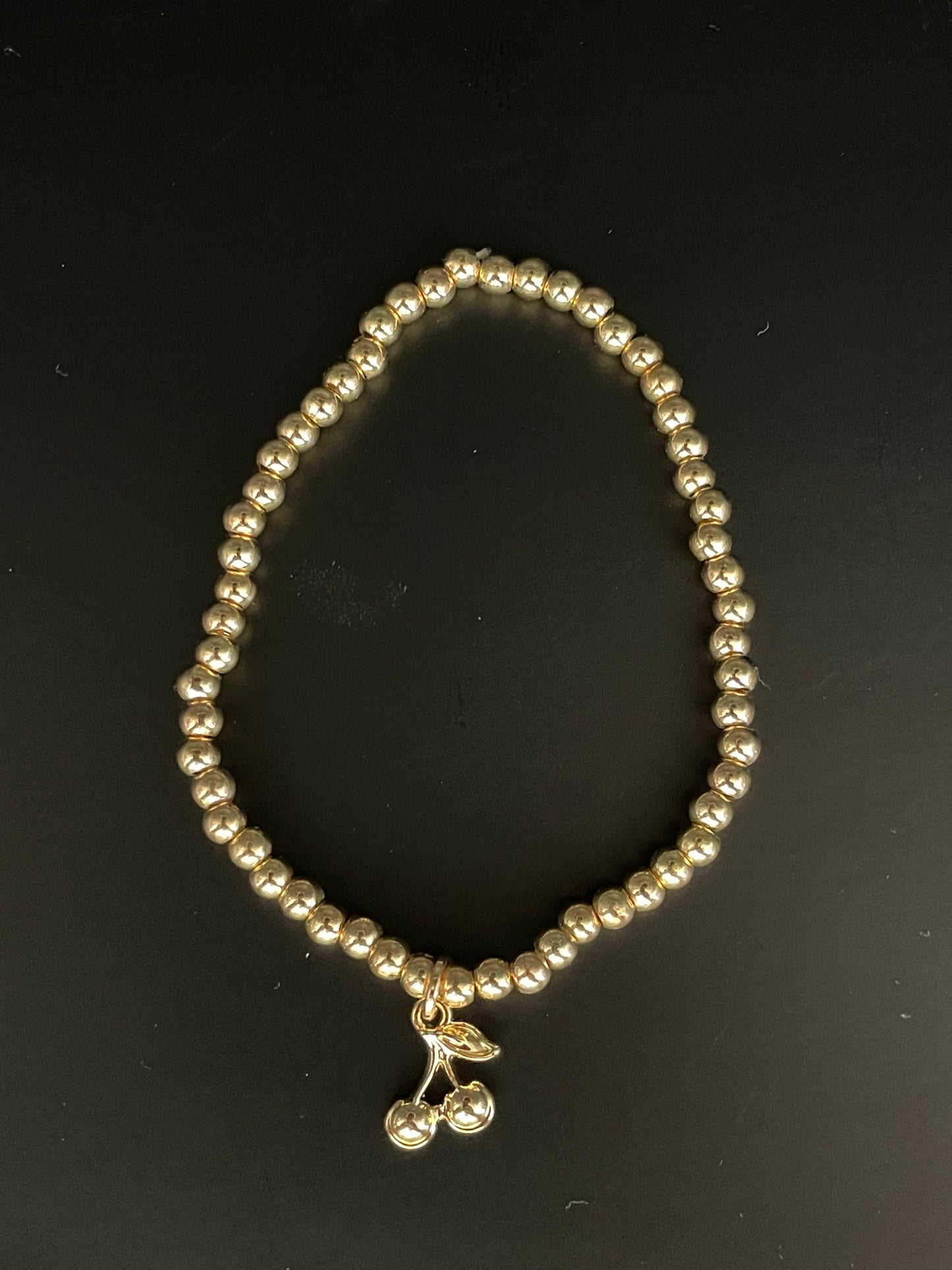 stretch armband goud/kers